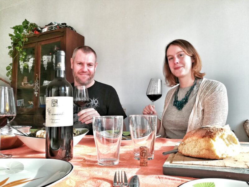 Local wine pouring during a home cooking experience in Puglia