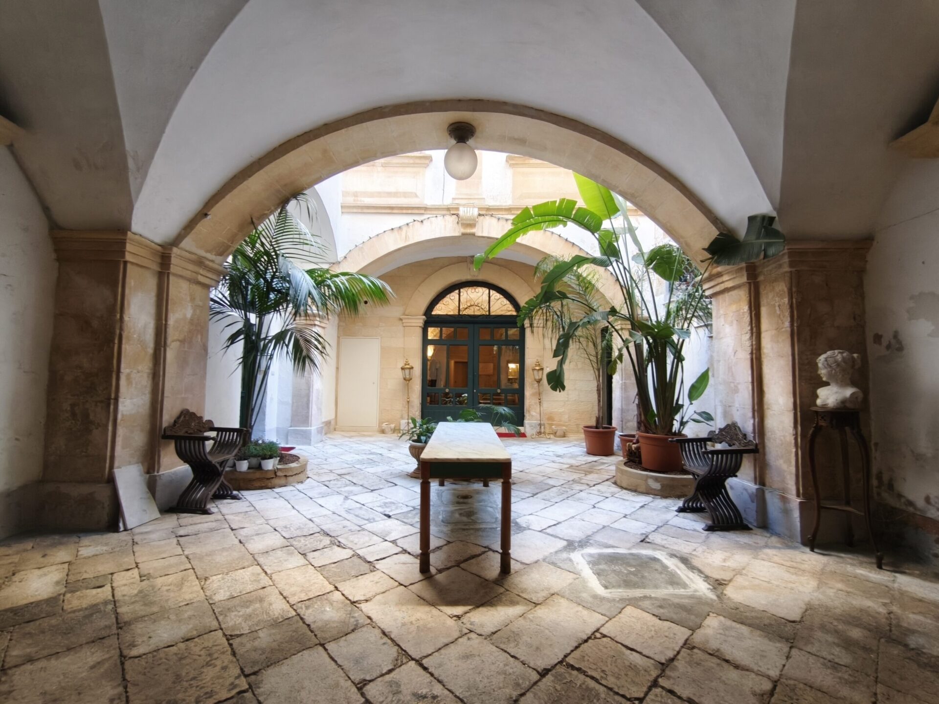 Cloistered internal courtyard of Palazzo Guido with loggia and original maiolica flooring