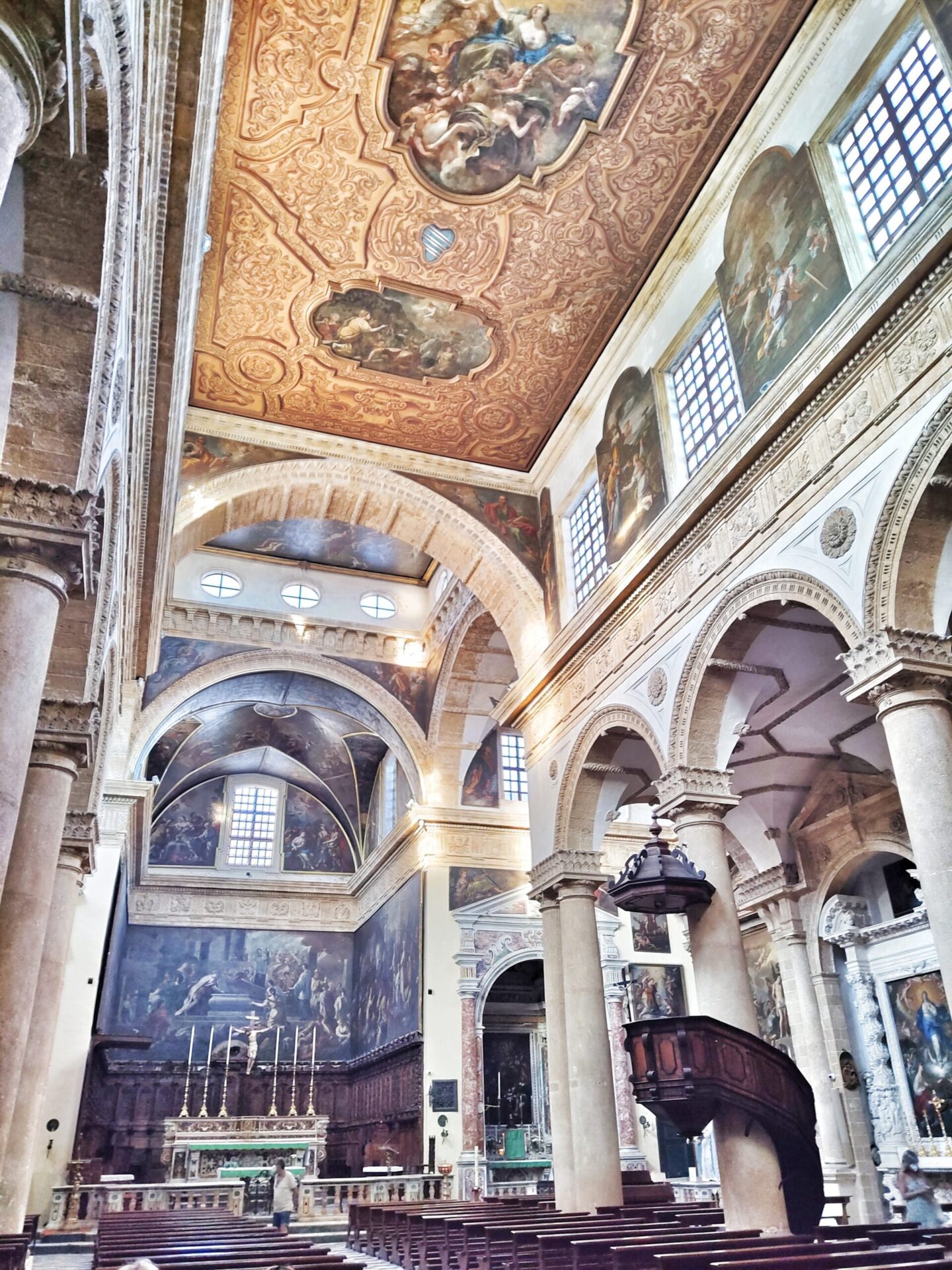 Baroque interior of Gallipoli's Sant'Agata Cathedral with ornate ceiling paintings and gilded altars