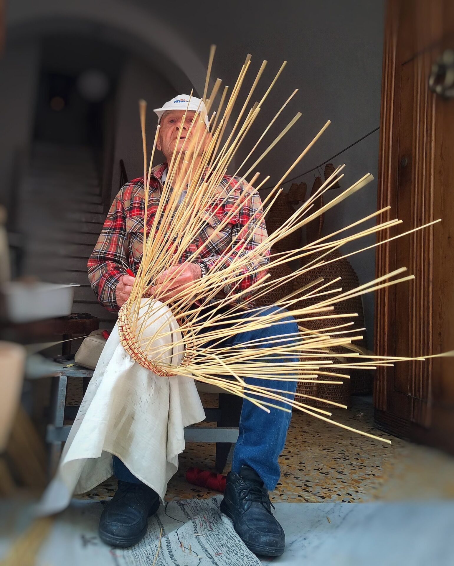 Master artisan weaving a traditional rush lobster trap in Gallipoli preserving ancient fishing craft