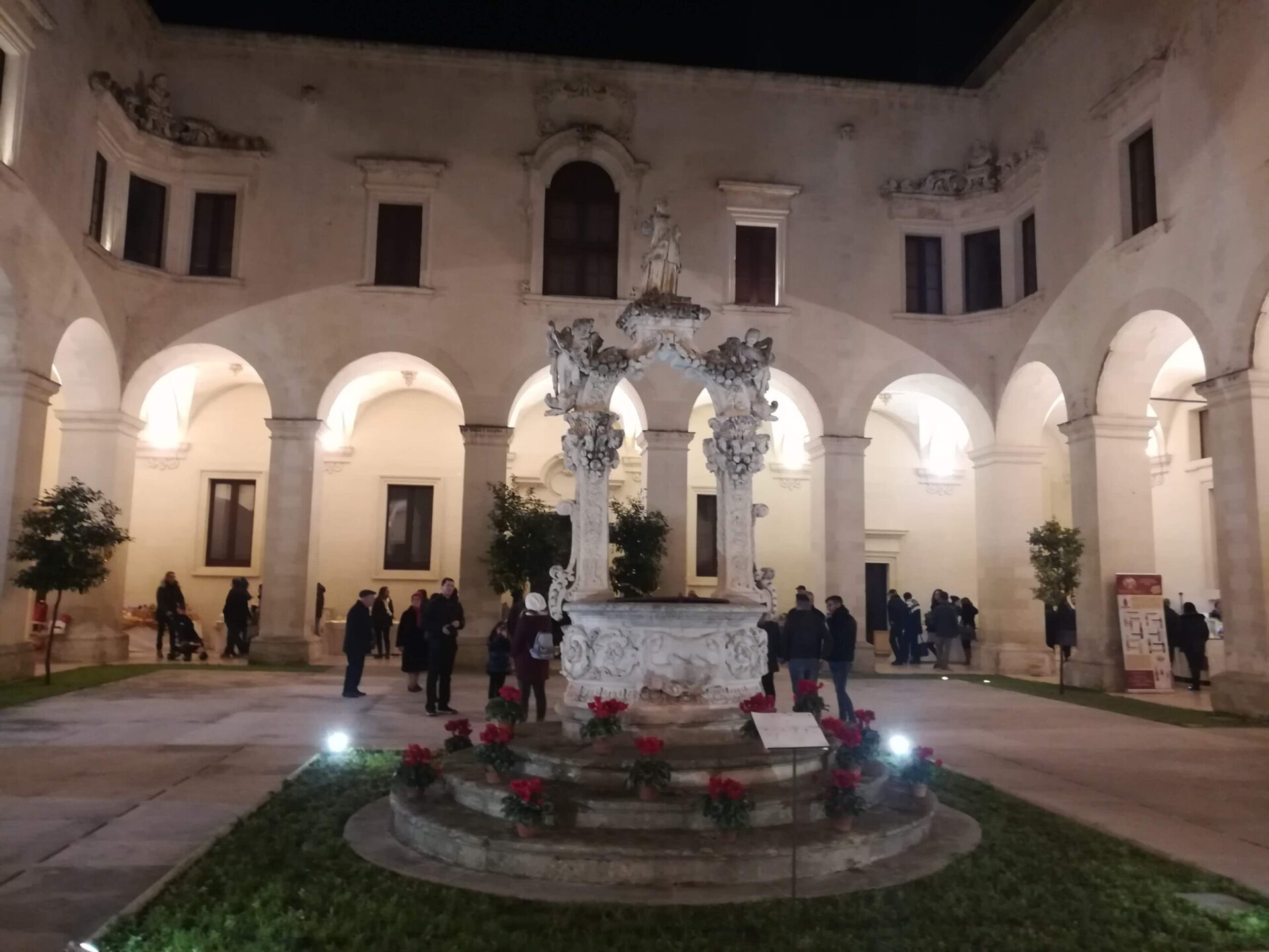 Ornate Baroque well in the courtyard of Lecce's Seminary Palace with carved marine and floral motifs