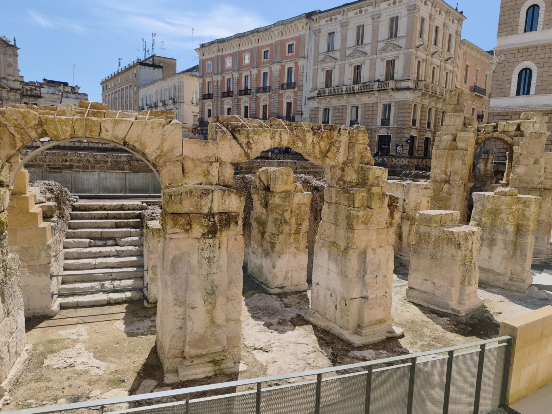 Partially excavated Roman amphitheater in Piazza Sant'Oronzo Lecce with elliptical seating and stone arcades