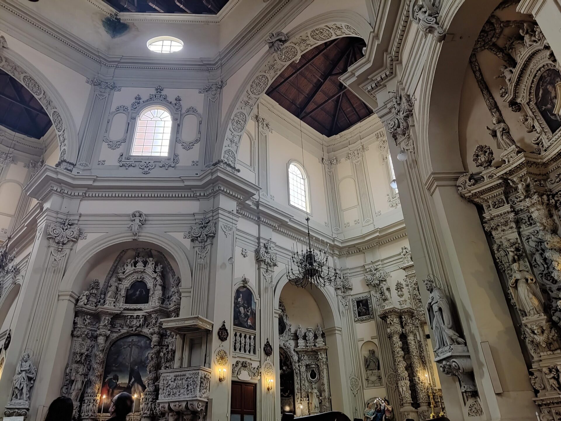Ornate Baroque interior of San Giovanni del Rosario church in Lecce with gold altars, frescoes and star-vaulted apse